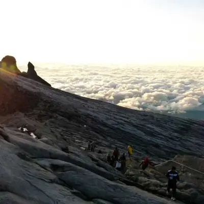Example social post photo of hikers above the clouds at sunrise